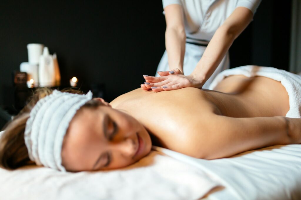 Massage therapist massaging woman