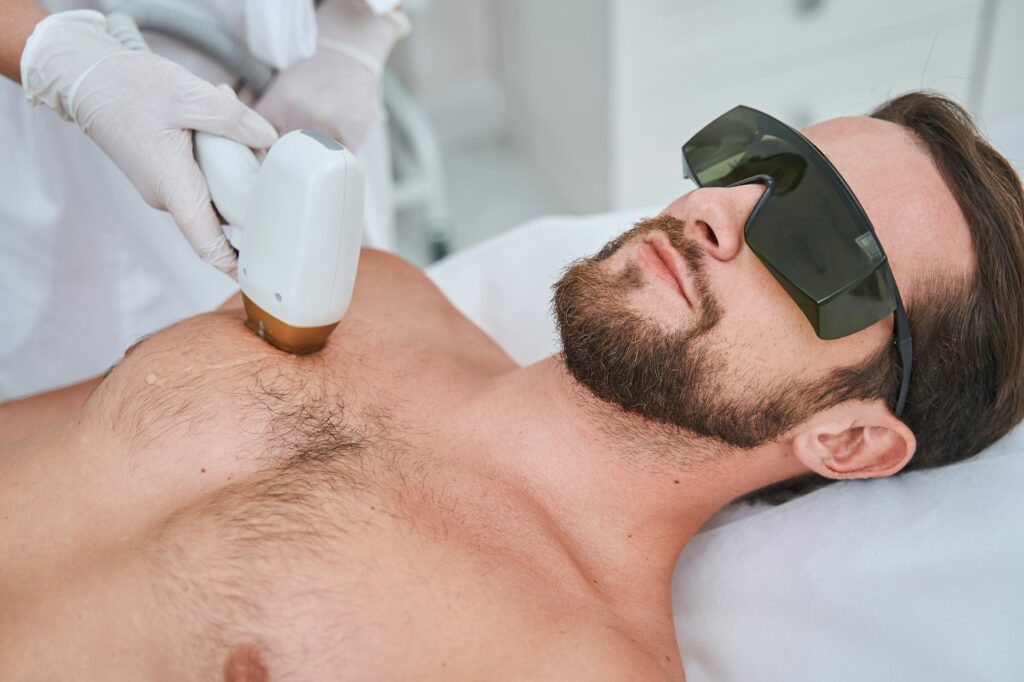 Beauty salon customer undergoing a laser chest hair removal