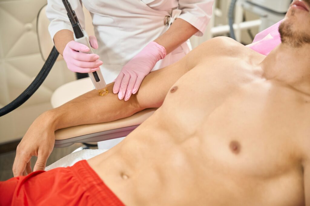 Man in red shorts at a laser hair removal session