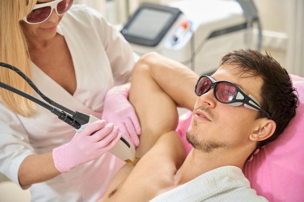 Specialist conducts a laser hair removal session in the armpits