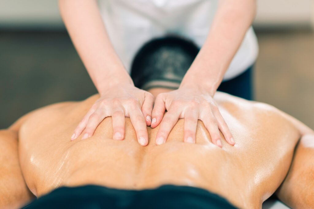 Sports massage. Therapist massaging sportsman's back